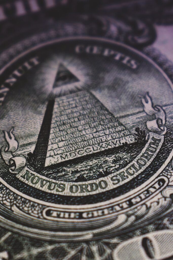 Detailed close-up of US dollar bill showing the Eye of Providence and pyramid design.